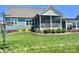 View of a screened porch and landscaped yard showing lush lawn and colorful flowers providing a tranquil outdoor setting at 1050 Coppergate Dr, Salisbury, NC 28147