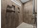 Modern tiled shower featuring built-in shelving and a sleek showerhead, designed for convenience at 1050 Coppergate Dr, Salisbury, NC 28147