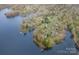 Wide aerial view of a lakeside community with lush greenery and glimpses of homes at 106 S Oakwood Dr, Kings Mountain, NC 28086