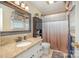 Bathroom with granite countertop vanity, decorative mirror, tile floors, and shower with curtain at 106 S Oakwood Dr, Kings Mountain, NC 28086