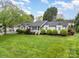 Charming single-story home features beautiful landscaping, a manicured lawn, and a welcoming front porch at 106 S Oakwood Dr, Kings Mountain, NC 28086