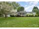 Well-maintained single-story home with a lush front lawn and mature trees, offering great curb appeal at 106 S Oakwood Dr, Kings Mountain, NC 28086