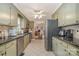 Bright kitchen with stainless steel appliances, ample counter space, and tile flooring at 106 S Oakwood Dr, Kings Mountain, NC 28086