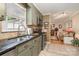 Kitchen featuring stainless steel appliances, tile backsplash, and view into living room at 106 S Oakwood Dr, Kings Mountain, NC 28086