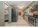 Kitchen with tile floors, stainless steel appliances, pantry, and view into dining area at 106 S Oakwood Dr, Kings Mountain, NC 28086