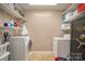Laundry room with white shelving, light brown walls, and a washer and dryer at 106 S Oakwood Dr, Kings Mountain, NC 28086