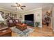 Inviting living room with hardwood floors, TV, and comfortable seating, perfect for relaxation and entertainment at 106 S Oakwood Dr, Kings Mountain, NC 28086
