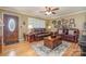 Cozy living room with hardwood floors, a ceiling fan, and a comfortable leather seating arrangement at 106 S Oakwood Dr, Kings Mountain, NC 28086