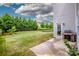 Expansive backyard with lush green grass, privacy trees, and a well-maintained lawn at 10707 Charmont Pl, Huntersville, NC 28078
