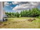 Large backyard featuring a well-maintained lawn and privacy trees at 10707 Charmont Pl, Huntersville, NC 28078