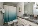 Bathroom featuring a granite countertop, white cabinetry, and decorative shower curtain at 10707 Charmont Pl, Huntersville, NC 28078