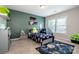 Bright bedroom with colorful decor, comfortable bed, and a view of the yard at 10707 Charmont Pl, Huntersville, NC 28078