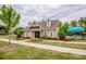 Community clubhouse with lush landscaping, mature trees, a pool, and outdoor amenities at 10707 Charmont Pl, Huntersville, NC 28078