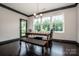 Charming dining room featuring dark trim, natural light, dark wood furniture, and view to the exterior at 10707 Charmont Pl, Huntersville, NC 28078