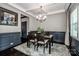 Elegant dining room features dark wood floors, wainscoting, and natural light at 10707 Charmont Pl, Huntersville, NC 28078