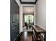 Hallway view to a dining room with a view to the exterior, neutral rug, wooden furniture, and wooden shelving at 10707 Charmont Pl, Huntersville, NC 28078