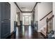 Inviting foyer with dark hardwood floors, staircase, wainscoting, and natural light at 10707 Charmont Pl, Huntersville, NC 28078
