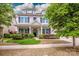 Charming two-story home with a well-manicured lawn, dormer windows, and inviting front porch at 10707 Charmont Pl, Huntersville, NC 28078