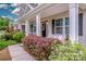 Inviting front porch with seating and colorful landscaping offering curb appeal at 10707 Charmont Pl, Huntersville, NC 28078