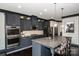 Well-appointed kitchen featuring granite countertops, stainless steel appliances, gray cabinets, and a spacious center island at 10707 Charmont Pl, Huntersville, NC 28078