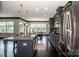 Open kitchen featuring a large island with pendant lights, stainless steel appliances, and a view to the breakfast area at 10707 Charmont Pl, Huntersville, NC 28078