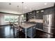 Kitchen island, dining nook, stainless refrigerator, granite countertops, and gray cabinets create an inviting space at 10707 Charmont Pl, Huntersville, NC 28078