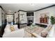 Bright living room with a fireplace, white sofas, and hardwood floors at 10707 Charmont Pl, Huntersville, NC 28078