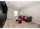 Cozy living room with neutral walls, stylish furniture, and bright natural light at 10707 Charmont Pl, Huntersville, NC 28078