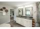 Bright main bathroom with dual vanities, granite countertops, and tiled floors and walk-in shower at 10707 Charmont Pl, Huntersville, NC 28078
