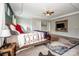 Large main bedroom featuring a wooden bed frame, ceiling fan, and decorative wall-mounted TV at 10707 Charmont Pl, Huntersville, NC 28078