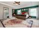 Bright main bedroom with a tray ceiling, large windows, area rug, and a full-length mirror at 10707 Charmont Pl, Huntersville, NC 28078