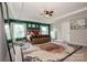 Spacious main bedroom with tray ceiling, natural light, a wooden bed frame, and a ceiling fan at 10707 Charmont Pl, Huntersville, NC 28078