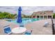 Community pool with shaded seating, tables, chairs, and lush landscaping for a resort-style experience at 10707 Charmont Pl, Huntersville, NC 28078