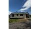 Rear view of the home showcases a white exterior, dark trim, gravel and a gray roof at 1104 Linwood Rd, Gastonia, NC 28052