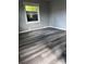 Bedroom with sleek gray walls, modern gray vinyl floors, and natural light, creating a serene space at 1104 Linwood Rd, Gastonia, NC 28052