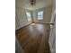 This bedroom features hardwood floors, base moulding, neutral paint, and dual windows at 1104 Linwood Rd, Gastonia, NC 28052