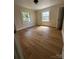 This bedroom features hardwood floors, base moulding, neutral paint and natural light at 1104 Linwood Rd, Gastonia, NC 28052