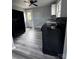 Eat-in kitchen boasts grey vinyl floors, black appliances, and ample natural light at 1104 Linwood Rd, Gastonia, NC 28052