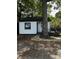 View of the home features an updated exterior, chimney, back deck and mature trees at 1104 Linwood Rd, Gastonia, NC 28052