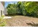 Large backyard with trees and partial fence, perfect for outdoor entertaining and recreation at 11220 Cypress View Dr, Charlotte, NC 28262