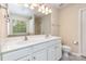 Bathroom with dual sinks, granite countertop, and large mirror. Natural light from the window at 11220 Cypress View Dr, Charlotte, NC 28262