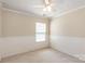 Bedroom features a window, neutral walls, crown molding, and paneled walls for added architectural detail at 11220 Cypress View Dr, Charlotte, NC 28262