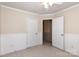 This is a bedroom with neutral walls, a ceiling fan, and paneled walls for added visual interest at 11220 Cypress View Dr, Charlotte, NC 28262