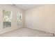 Bright bedroom featuring carpeted floors and two windows to provide lots of natural light at 11220 Cypress View Dr, Charlotte, NC 28262
