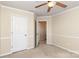 Cozy bedroom featuring a ceiling fan and access to a closet and other rooms at 11220 Cypress View Dr, Charlotte, NC 28262