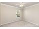Bedroom features a window, neutral walls, and a ceiling fan at 11220 Cypress View Dr, Charlotte, NC 28262