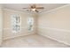 Bedroom with two windows for natural light, chair-rail molding, neutral carpet and a ceiling fan at 11220 Cypress View Dr, Charlotte, NC 28262