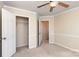 Bedroom with a closet, neutral carpet, ceiling fan and access to other rooms at 11220 Cypress View Dr, Charlotte, NC 28262