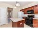 Kitchen featuring an island, stainless steel appliances, and wooden cabinets at 11220 Cypress View Dr, Charlotte, NC 28262