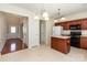 Open kitchen featuring wooden cabinets, island, and black appliances at 11220 Cypress View Dr, Charlotte, NC 28262